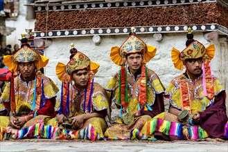 Colourfully dressed monks watching the opening ceremony of the Hemis Festival
