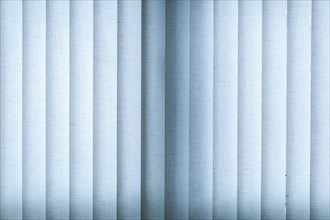 Blue blinds made of fabric with backlighting