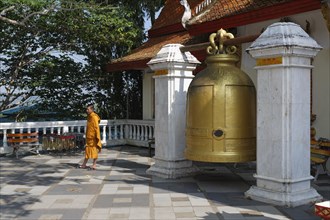 Large bell with a Buddhist monk in the temple complex of Wat Phra That Doi Suthep Ratcha Woraviharn
