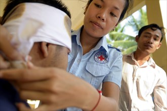 Young woman applying a head bandage