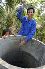 Man fetching water from a well