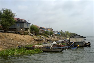 Bank of the river Prek Tnort with fishing boats and stilt houses