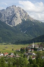 Village of Lermoos in Ehrwalder Becken in front of Gruenstein Mountain