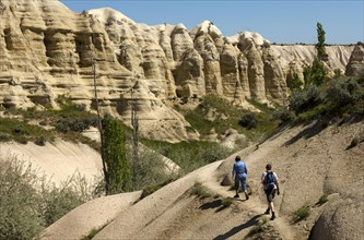 Hikers in "Love Valley" or Ask Vadisi in a tufa landscape