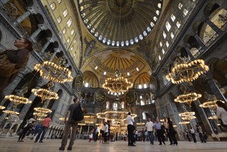 Tourists admiring the main hall of Hagia Sophia