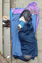 Homeless man sleeping on the ground