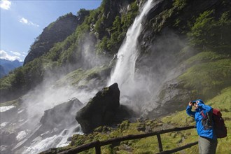 A man hiking at the waterfall of Foroglio