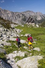 Two hikers heading towards the Rifugio Garelli mountain hut