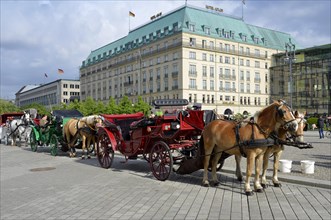 Horse-drawn carriages for tourists outside the Adlon Hotel