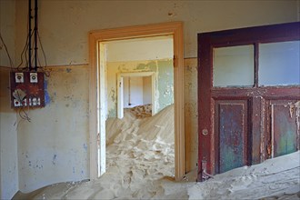 Room in a house that has been filled by desert sand