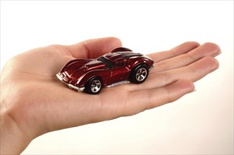 Hand holding a miniature car
