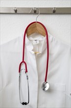Doctor's coat hanging on a coat hanger on a coat rack