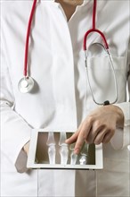 Female doctor holding a tablet computer