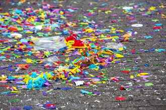 Confetti lying in the street after a carnival parade