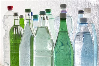 Different varieties of mineral water in bottles made of glass and plastic or PET