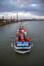 Container ship on the Rhine travelling upstream at Duisburg-Homberg
