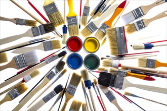 Different types of brushes and cans of paint