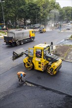 Rolling machines during asphalt work on a large urban road construction site