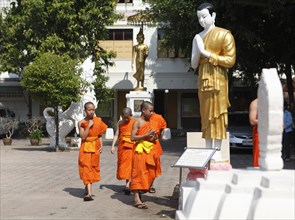 Young monks in the courtyard of the Wat Phra Singha temple