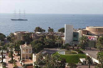 View from the balcony of the Monte Carlo Bay Hotel & Resort over the garden and  Jimmy'z Night Club towards the sea with the large yacht Maltese Falcon