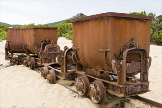 Tippers or tipping wagons on old mine tracks in the dunes