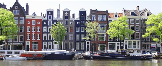 Typical canal houses and boats along the Amstel Canal