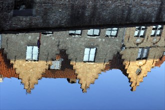 Guild houses with stepped gables being reflected in Dijver canal