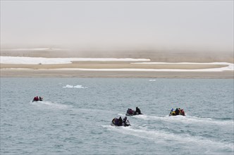 Zodiac inflatable boats transporting passengers from an expedition cruise to the shore