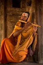 Sadhu playing a flute