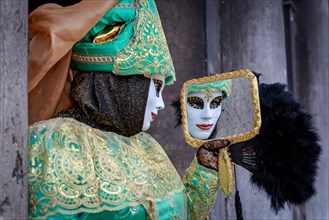 Masked woman with a mirror at the Carnival in Venice