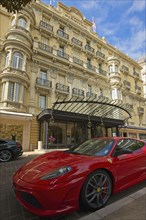 Red Ferrari parked in front of the Hermitage Hotel