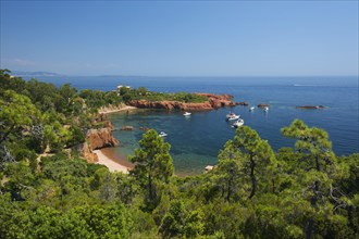 Calanque bay with boats at Cap Roux in the Esterel mountains