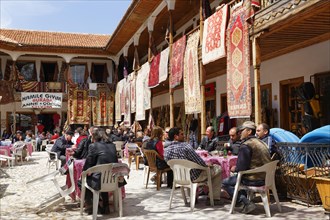 Carpet merchants and a tea garden in a bazaar