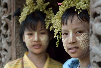 Young girls with thanaka and flower decoration