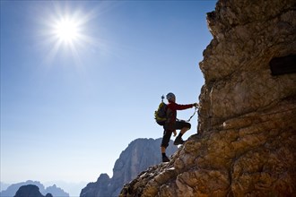 Mountain climber climbing the Marino Bianchi climbing route on Monte Cristallo to the summit of Cristallo di Mezzo