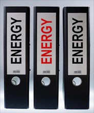 Three ring binders labeled Energy