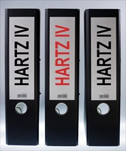 Three ring binders labeled Hartz IV