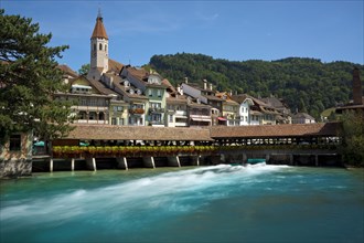 View over the Aare River and the old lock towards the historic town centre with the town church