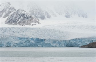 Glacial ice in the rocks surrounding a fjord