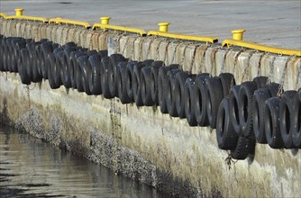 Row of car tyres in the harbour of Honningsvåg