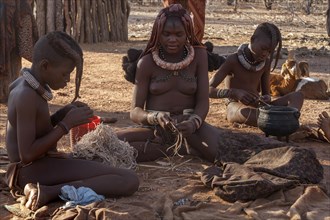 Traditionally dressed Himba people in the Otjikandero Himba Orphan Village