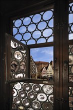 Pilatushaus building seen through a window of Albrecht Duerer House