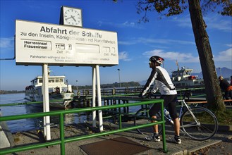 Racing cyclist standing at the pier at Prien