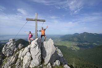 Hikers standing next to the cross on the summit of Friedenrath mountain