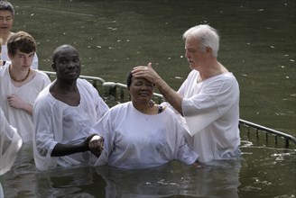 Woman being baptised in the Jordan River at the Yardenit baptismal site