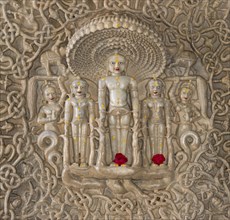 Tirthankar Parshvanat in the medallion protected by the thousand-headed serpent God Dharanendra against a powerful storm