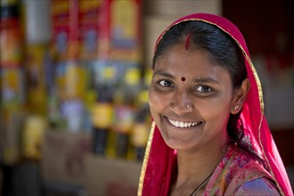 Smiling Indian woman wearing a dupatta scarf with a bindi