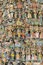 Colourful statues of gods and demons on the Gopuram or Gopura gate tower