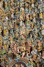 Colourful statues of gods and demons on the Gopuram or Gopura gate tower
