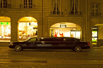 Black stretch limousine in Gerechtigkeitsgasse street at night